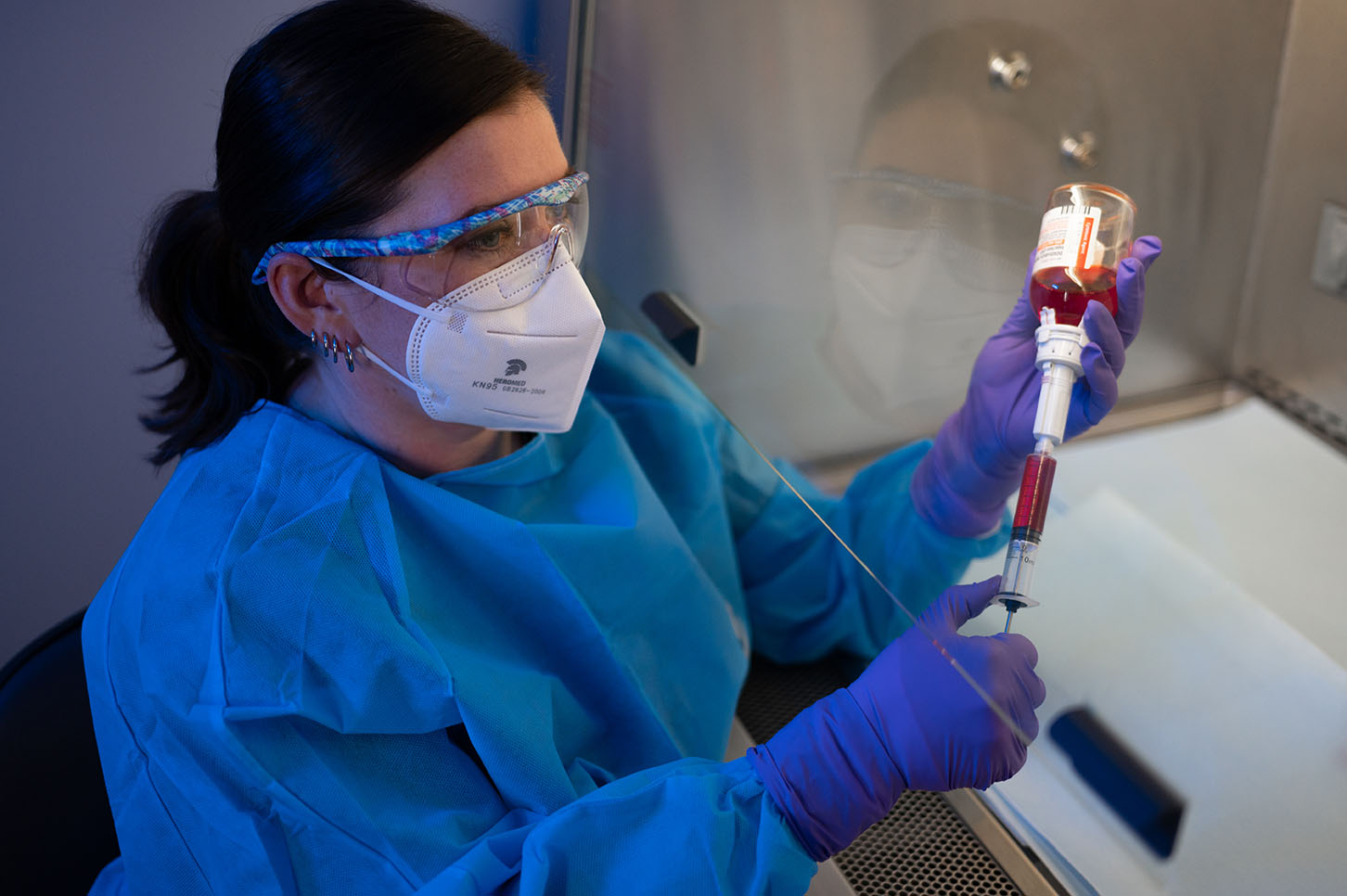 Megan Lee, VTS, prepares chemotherapy drugs in the hood.